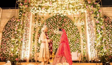 This couple’s plush wedding reflected the vibrancy of Gujrati culture with its tall gold archways, pink blooms, and vintage chandeliers